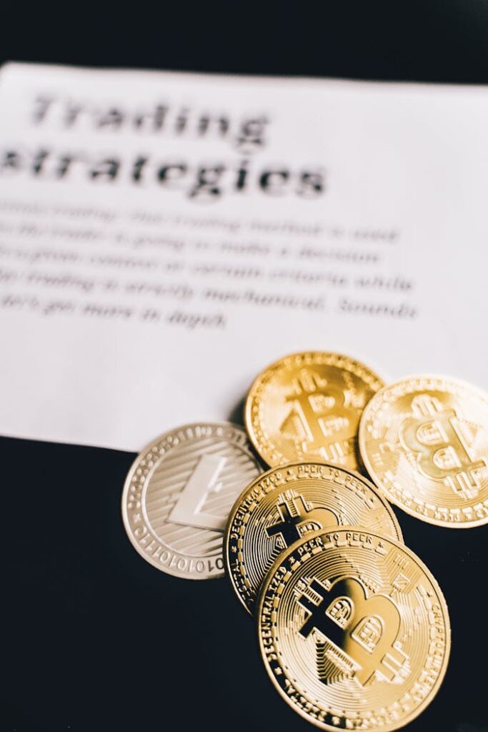 Close-up of Bitcoin and Litecoin coins on a trading strategies document.